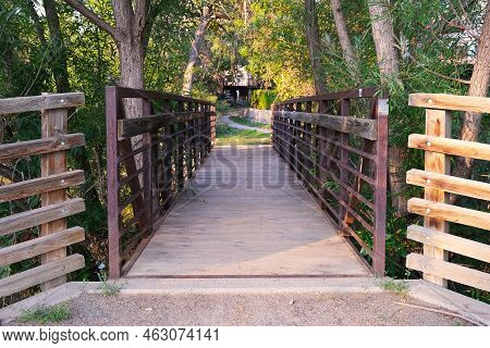 Perspective View Of Pedestrian Bridge Over Creek Along Hiking Trail In Forest Park Outdoors Scenic L