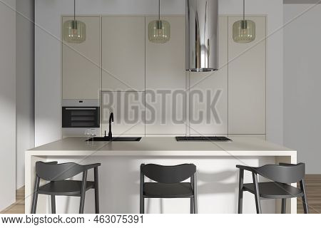 Front View On Bright Kitchen Room Interior With Island, Barstools, Cupboard, White Wall, Oven, Gas C