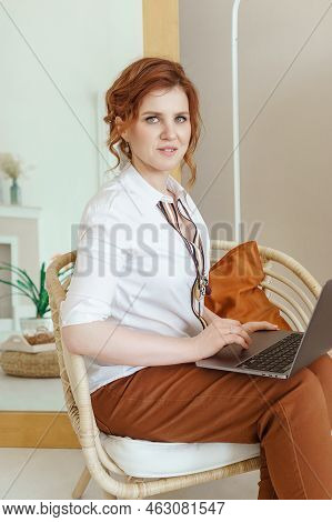 A Business Woman With A Laptop. A Human Design Specialist Works At Home On A Laptop. Work From Home 