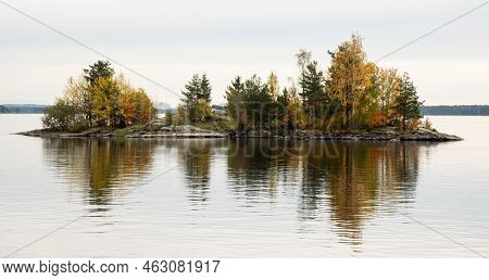 Island In A Lake With Trees In Autumn Reflected On Water. Kuopio Finland Europe