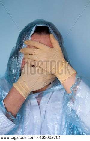 Woman In A Protective Suit Closing Her Face. Distressed Woman. Coronavirus (covid-19) Disease Outbre