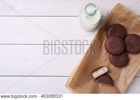 Tasty Choco Pies And Milk On White Wooden Table, Flat Lay. Space For Text