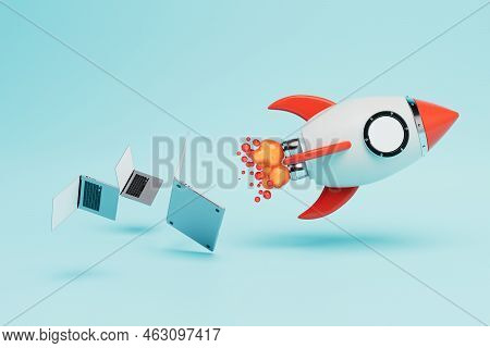Rapid Development Of Internet Technologies. A Rocket Taking Off Next Which Laptops On A Blue Backgro