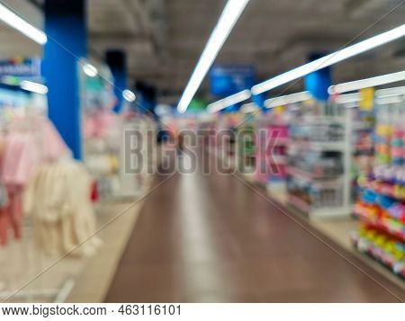 Abstract Blur Empty Supermarket Discount Store Aisle And Product Shelves Interior Defocused Backgrou
