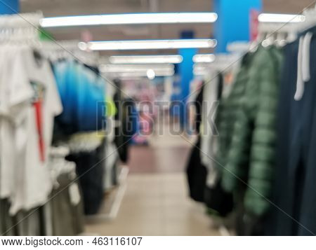 Blurred Children Clothing Store With Discount Sign And Variety Of Clothes For Newborn, Kids, Toddler