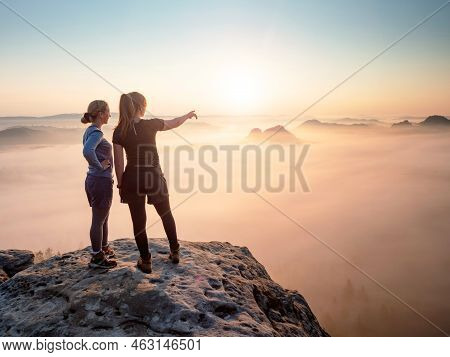 Kleiner Winterberg, Germany. June 27 2021. Fearless Girls On Rocky Edge. Hiker Shows Girl Friend Som