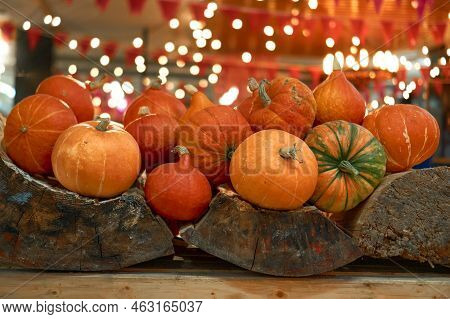 Autumn Harvest Concept. Bunch Of Appetizing Orange Pumpkins On Wood, Backdrop Bokeh Blurred Light Bu
