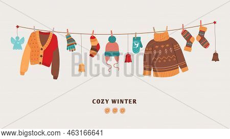 Cozy Winter Banner With Knitted Warm Sweaters On Rope. Seasonal Clothes And Accessories, Socks And M