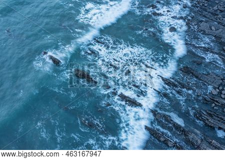 Aerial Drone Landscape Bird's Eye View Of Sunset Over Welcombe Mouth Beach In Devon England