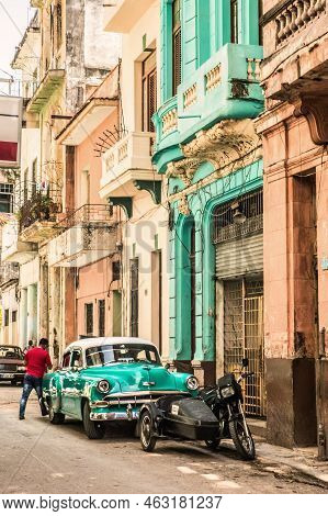 Havana, Cuba - July 18 2018 : A Colorful View, A Green House And His Green Car On The Streets Of Old