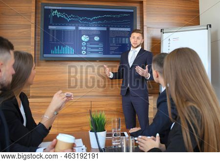 Business Team At Office, Businessman Presenting And Discussing Successful Financial Report Of Their 