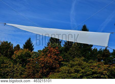 White Tarpaulin Taut, Shading From The Sun And Rain Over The Terrace Of The Restaurant, On The Playg