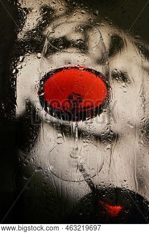 Abstract Glass Of Dry Red Wine Through Rainy Window