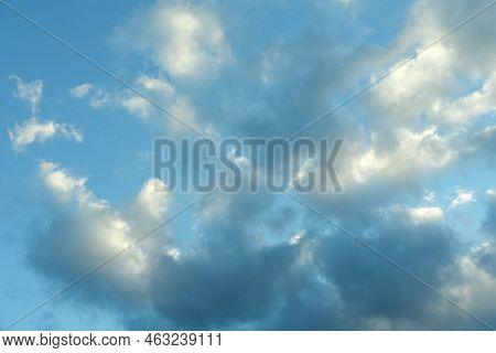 Blue Sky Background With White Fluffy Cumulus Clouds. Panorama Of White Fluffy Clouds In The Blue Sk
