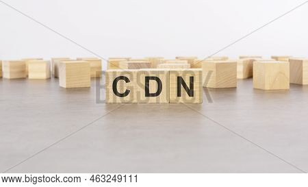 Cdn - Content Delivery Network - Acronym On Wooden Cubes On Columns Of Numbers Background.