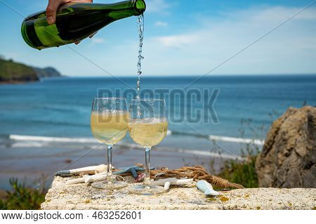 Pouring Of Txakoli Or Chacolí Slightly Sparkling Very Dry White Wine Produced In The Spanish Basque