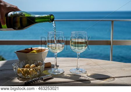 Pouring Of Txakoli Or Chacolí Slightly Sparkling Very Dry White Wine Produced In The Spanish Basque