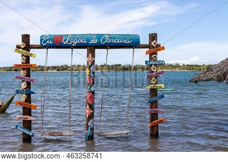 Several Posters With Words In Portuguese Next To Two Hammocks In The Carcara Lagoon. Words Of Good V