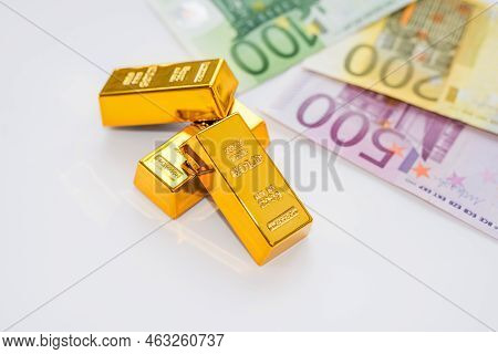 Euro Banknotes And Gold Ingots Close Up