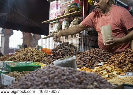 Beni Mellal, Morocco - October 11, 2022: Street Vendor Serving A Moroccan Customer Serving Him Dates