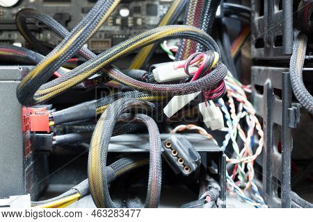 Very Dirty Wires, Connectors And Plugs In The Computer. Old Multi-colored Wires In A Braided Wrapper