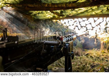 Close-up Soldiers Firing A 50 Cal Machine Gun With Spent Brass Around It