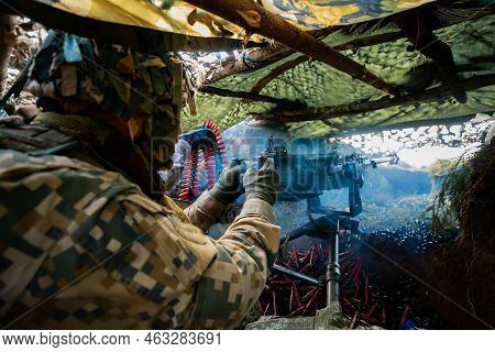Close-up Soldiers Firing A 50 Cal Machine Gun With Spent Brass Around It