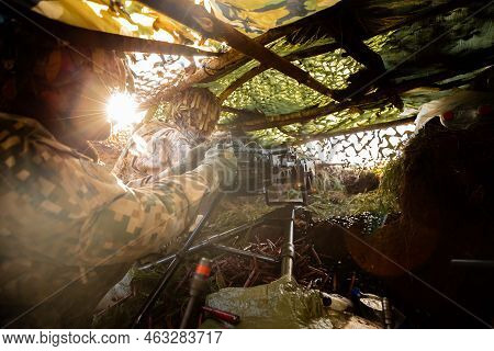 Close-up Soldiers Firing A 50 Cal Machine Gun With Spent Brass Around It