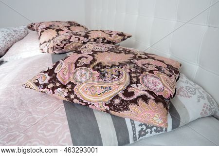 Pink Decorative Pillows On The Bed Linen. Double Bridal Bed With Pillows And Thick Feather Duvet. Be