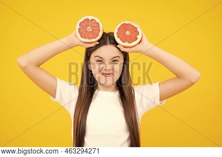 Funny Face. Happy Teenager Girl Hold Grapefruit Orangeisolated On Yellow Background, Kids Fruits Vit