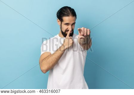 Portrait Of Man Wearing White T-shirt Looking With Incredulous Gaze And Touching Nose, Gesturing You