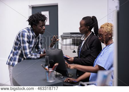 Medical Team Helping Patient With Appointment, Having Checkup Visit Consultation With Specialist And