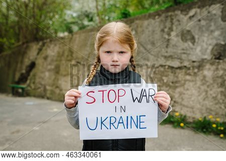 Upset Poor Toddler Girl Kid Protesting War Conflict Raises Banner With Inscription Message Text Stop