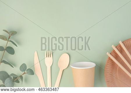 Eco - Friendly Tableware On Green Background. Top View. Plastic Free Set Of Brown Paper Utensil. Str