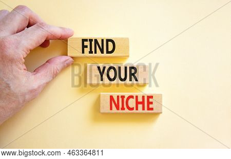 Find Your Niche Symbol. Concept Words Find Your Niche On Wooden Blocks. Businessman Hand. Beautiful 