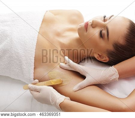 Hair Removal, Beauty And Health Concept. A Young Girl Is Getting An Epilation Procedure. A Processio
