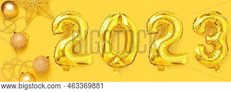 Golden Foil Balloons With The Number 2023. Happy New Year And Christmas Holiday Concept. Top View Co