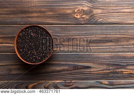 Quinoa Seeds In Bowl On Colored Background. Healthy Kinwa In Small Bowl. Healthy Superfood.