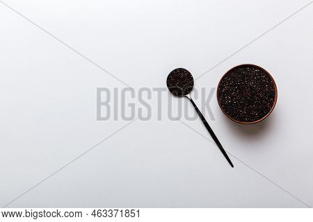 Quinoa Seeds In Bowl And Spoon On Colored Background. Healthy Kinwa In Small Bowl. Healthy Superfood