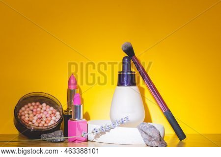Makeup Products And Decorative Cosmetics On Zellow Background Flat Lay. Fashion And Beauty Blogger C