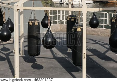 Set Of Black Punching Bags, Boxing Pears For Kickboxing And Fitness Exercises. Modern City Open-air 