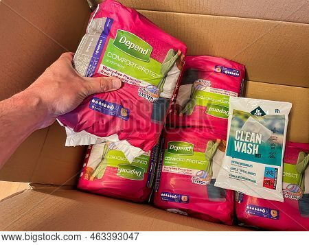 Den Haag, Netherlands - June 01 2022 : Opening A Box Of Incontinence Material Send In An Discreet Br