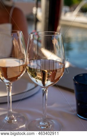 Dinner At Sunset In French Restaurant With Cold Dry Rose Wine In Port Grimaud, Summer Vacation On Fr