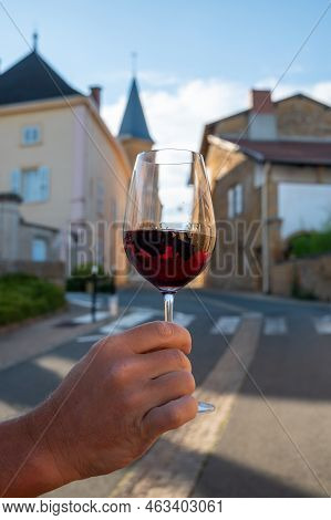 Tasting Of Red Wine By Old Wine Maker In Pierres Dorées Region With Yellow Stone Houses On South Of