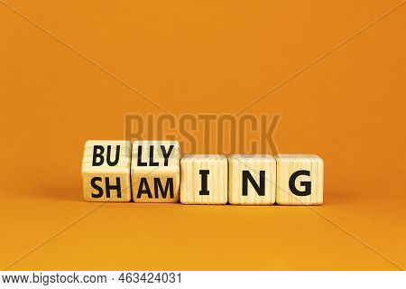 Shaming And Bullying Symbol. Concept Words Shaming And Bullying On Wooden Cubes. Beautiful Orange Ta