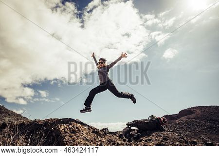 Young Middle Age Woman Jump To The Stones For Happiness And Success Concept During A Travel Touristi