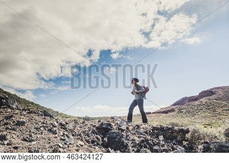 Beautiful Young Caucasian Woman Hike And Do Trekking Activity At The Mountain Enjoying Freedom Outdo