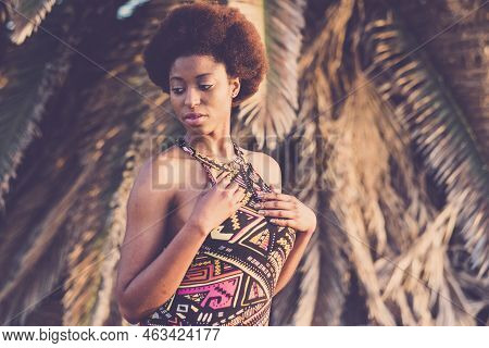 Black African Beautiful Young Woman Pose With Athnic Traditional Dress And Afro Hairstyle With Tropi