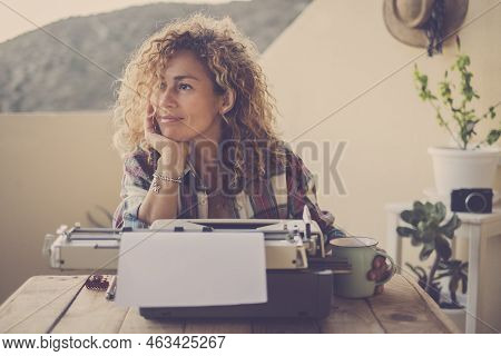 Beautiful Happy Relaxed Middle Age Caucasian Woman Blonde Curly Hair Taking A Break And Stop Writing