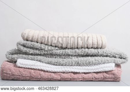 Hello Winter. Cozy Warm Apparel. Stack Of Winter Warm Sweaters On Grey Table, Comfort Organic Sweate